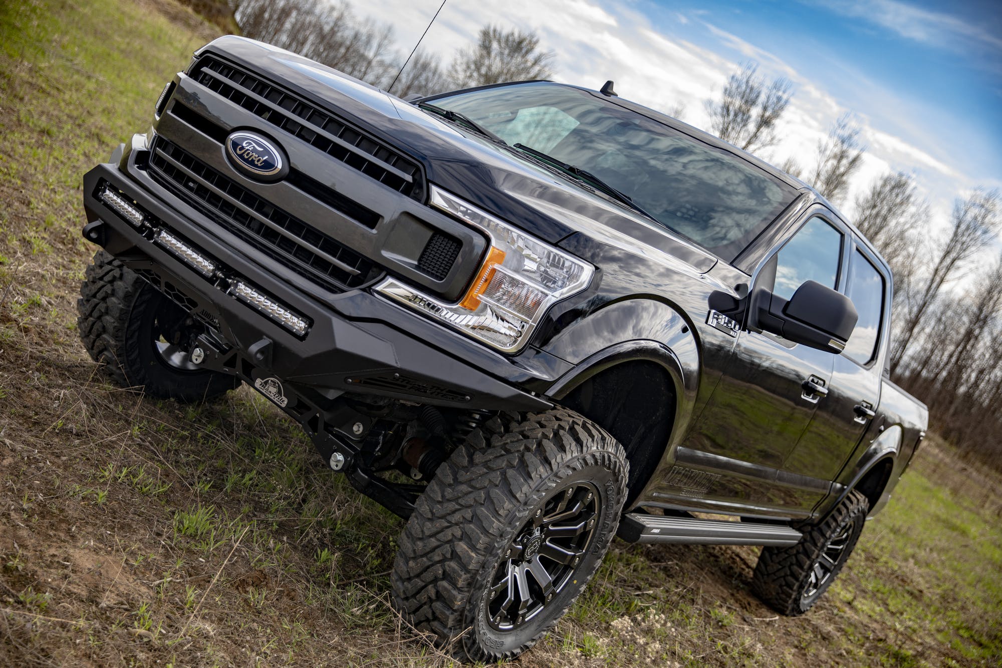 F-150 aftermarket parts front bumper grille and offroad tires