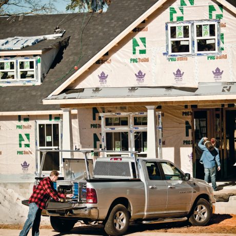 Construction site with truck man and house